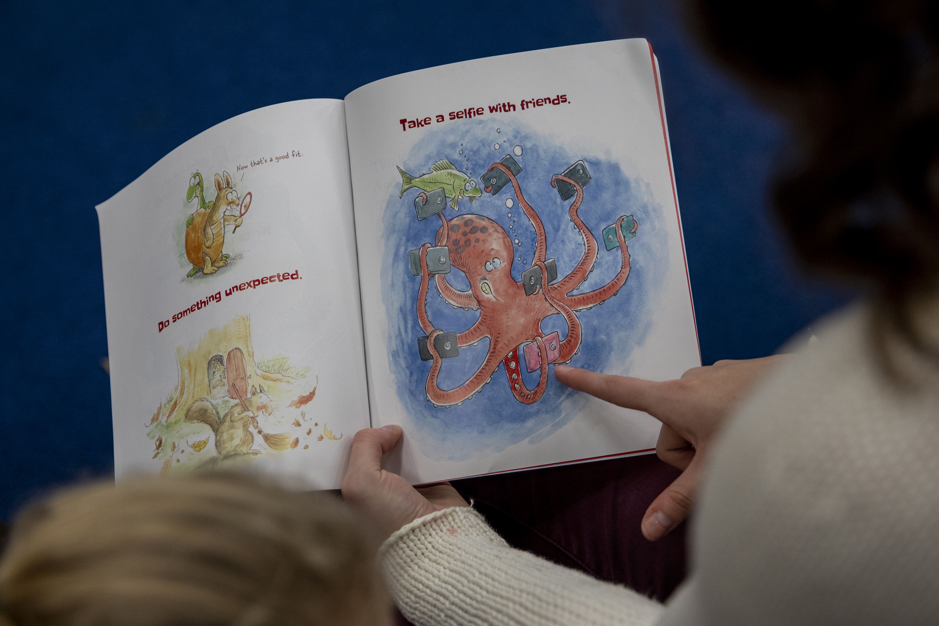 The pair reads a book Alana bought for Miracle, who was born with some vision issues. Alana began working with Miracle in 2016. They meet twice a month on Fridays to read stories and play on Alana’s phone.
