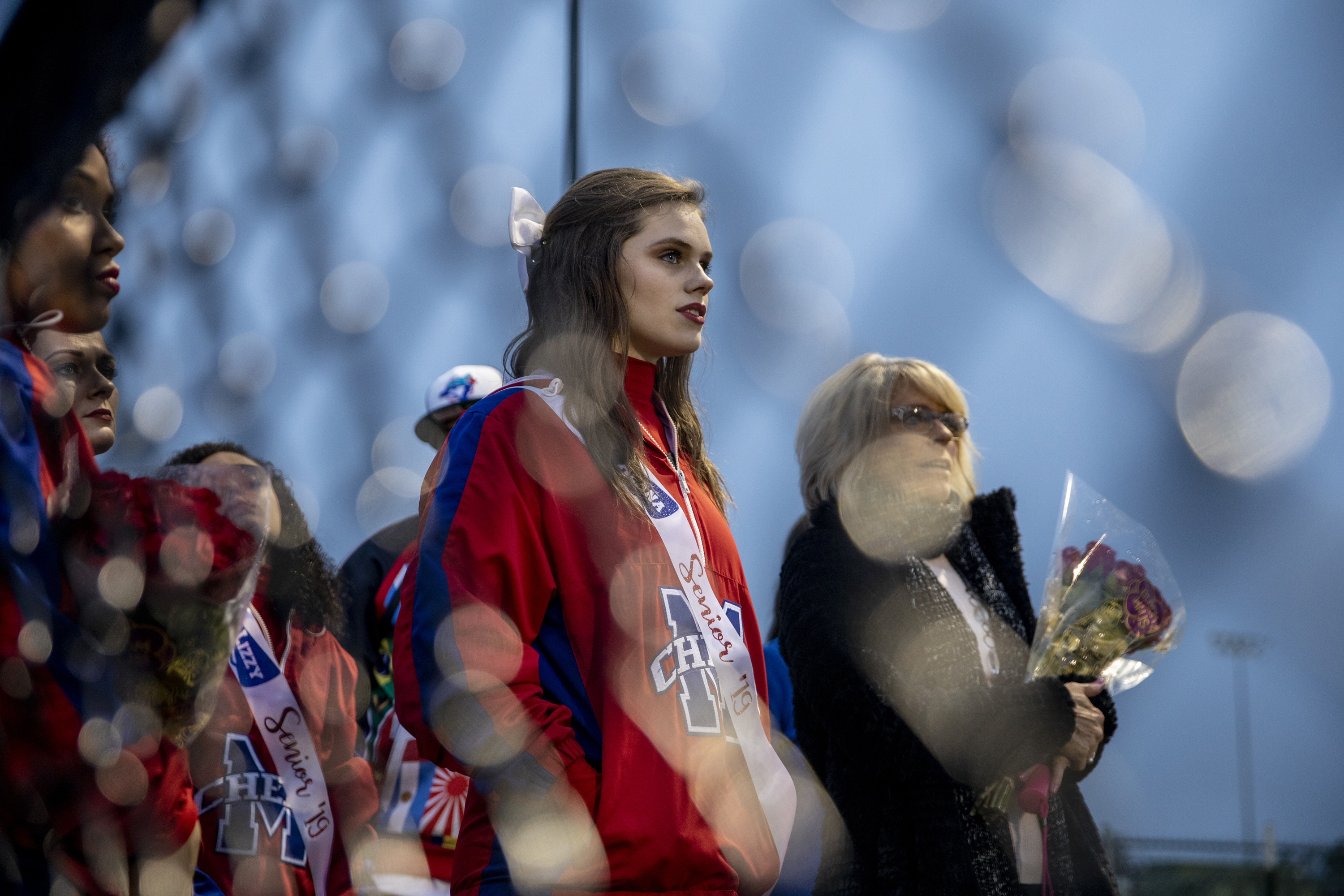 Alana and her mom wait on the sidelines before being called onto the football field, where seniors participating in fall sports would be honored ahead of a game against Lincoln County High School. 